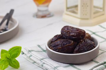 Kurma dan Air Putih, Medjool Dates and water on marble white background. Breakfasting concept in Ramadan month. Islamic template for text background. 