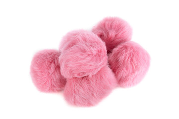 Close up of pink rabbit fur pompoms isolated on white background.