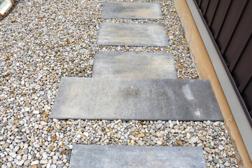 Precast concrete steps provide a safe and comfortable hardscape solution to address the steep grade between two houses.