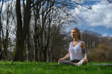 Fototapeta na wymiar Yoga practice and meditation outdoor. Girl in the park