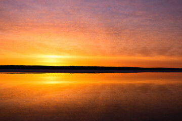 Sunrise over mirror calm lake