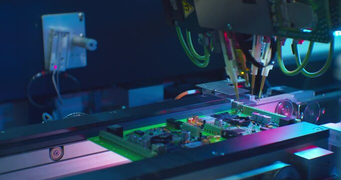 Modern industrial electronics manufacturing equipment makes a complex printed circuit board.High-tech production close-up.