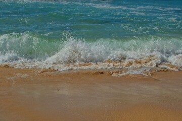 Waves rolling up on sandy beach - close up	
