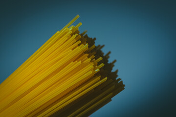Durum wheat spaghetti on a dark blue background.