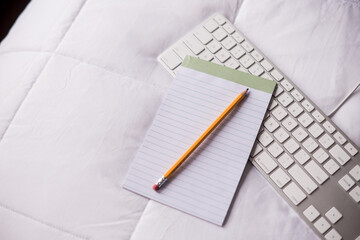 notepad set atop keyboard