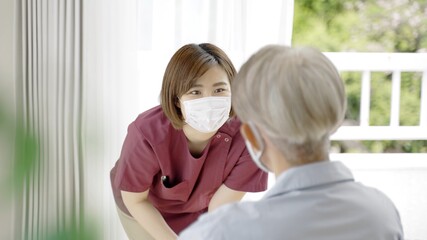 Fototapeta premium 患者に説明をするマスクを着用した看護師