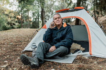 Elderly man searching for internet connection in the forest © Rawpixel.com