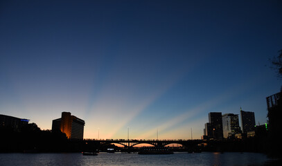 Medium distant view of bridge from river at sunset