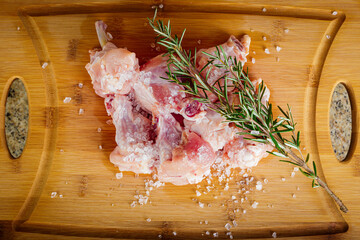 thigh wing chicken With herbs and salt. Wooden background.
