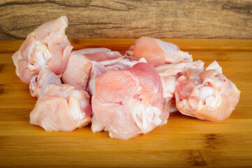 thigh wing chicken. Wooden background. Front view.