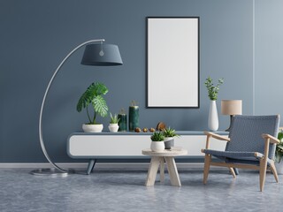 Poster mockup with vertical frames on empty dark green wall in living room interior with dark blue velvet armchair.