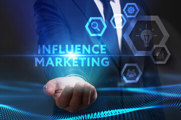 Business, Technology, Internet and network concept. Young businessman working on a virtual screen of the future and sees the inscription: Influence marketing