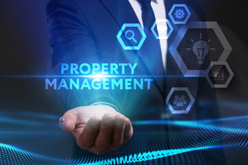 Business, Technology, Internet and network concept. Young businessman working on a virtual screen of the future and sees the inscription: Property management