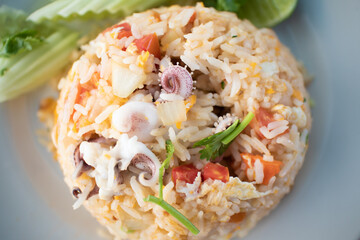 Thai Squid Fried Rice or Thai Seafood Fried Rice served on white dish.