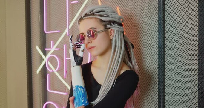 The woman with glasses and the bionic prosthesis Bionics Cybernetic Robotic-arm Hand prosthesis