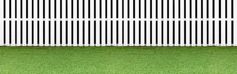 Panorama of New wooden fence painted white and fresh green lawn floor pattern and background seamless