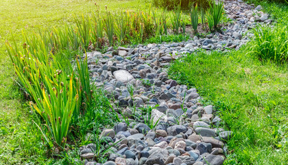 River from stone in a green garden. Garden Decoration Concept Decor, Landscape Design
