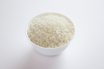 Fototapeta na wymiar rice grains in a bowl isolated on white background.