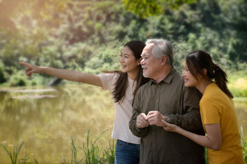 senior asian with family  enjoying good time , happy and smiling,outdoors family at nature park...