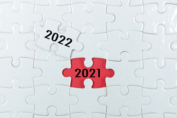 2021, 2022 on puzzle background, business concept.