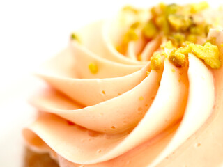 Macro close up on a cupcake with pink icing