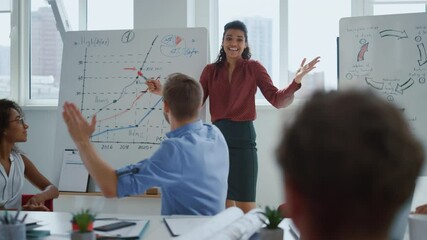 Happy colleagues celebrating success office. Team applauding afro businesswoman
