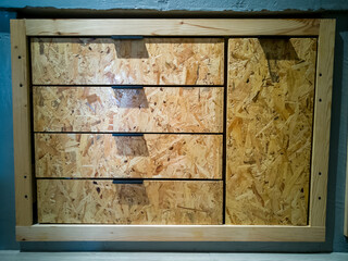 Wooden kitchen drawer, kitchen in a bare finishing style from osb board.