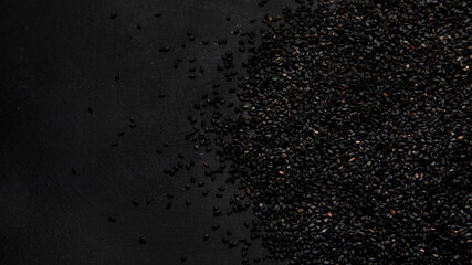 Fototapeta na wymiar Black sesame seed on black background. Organic food concept.