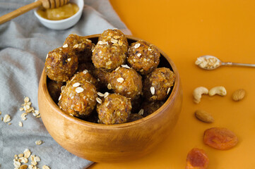 Raw energy balls. Candy vegan balls of dates, raisins, almonds, cashews, dried apricots, oatmeal.