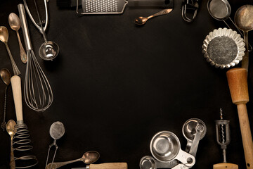 Set of kitchen utensils on black background. Tools for cooking.