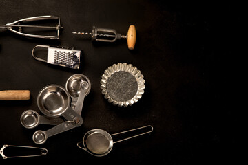 Set of kitchen utensils on black background. Tools for cooking.