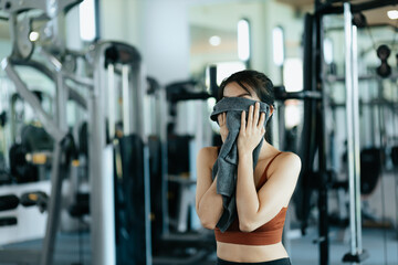 Fototapeta premium sport woman resting after workout and wipe the sweat by towel. sport and workout concept.