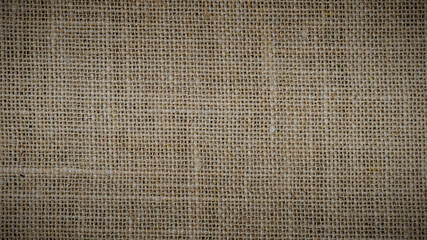 Hessian sackcloth burlap woven texture background, Cotton woven fabric close up with flecks of varying colors of beige and brown, with copy space for text decoration.