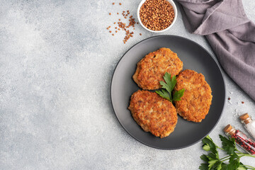 Buckwheat cutlets with cheese and parsley on a plate. Healthy diet food copy space, top view.