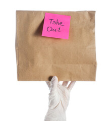 Fototapeta premium Female hand in medical glove with paper bag and sticker TAKE OUT on white background