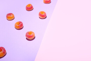 Tasty jelly candies on color background