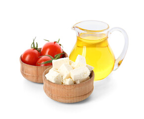 Bowls with tasty feta cheese, tomatoes and oil on white background