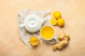 Teapot and cup of tea with ginger on color background