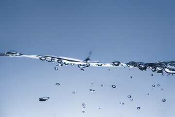 Water splash Aqua flowing in waves and creating bubbles Drops on the water surface feel fresh and clean isolated on white background.