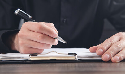 Male Judge signing in document. Justice and Law concept