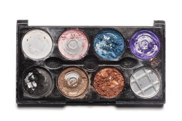 Old used eye shadows palette isolated on the white background. Top view.