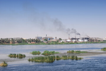 Fototapeta premium Factory on the Nile river shore, southern Egypt, Africa. Cruising on Nile River.