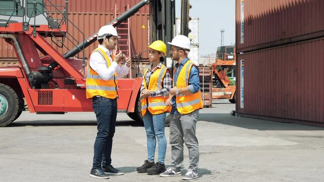Architect of engineer and dock worker staff working discussing in shipping yard at Container cargo harbor. Business logistic commercial intermodal freight transport in import export, Cargo ship. 4K
