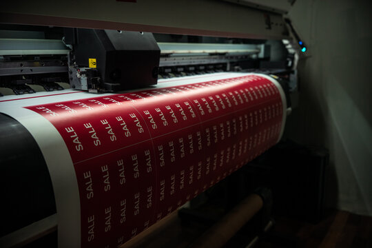 Printing of adhesive film with the inscription sale on the printing press