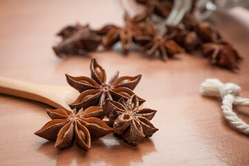 Some star anise seeds and fruits on wooden spoon