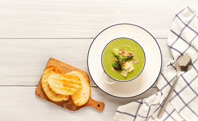 Cream soup, green asparagus, on a white background, healthy food, horizontal, no people,