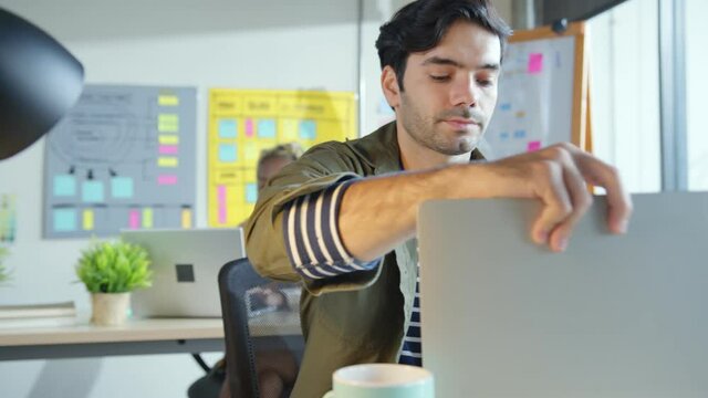 Male Caucasian creative designer relax communication conversation with senior programer caucasian coworker in modern startup office workplace business concept