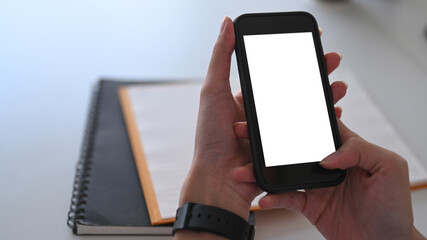 Close up view woman hands holding smart phone with white screen.