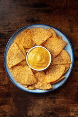Nachos, Mexican tortilla chips, shot from above on a wooden table
