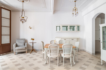 Dining table in a center of living room decorated in retro style. Tile floor and vintage...